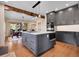 A modern kitchen features a large center island, state-of-the-art appliances, dark cabinetry, and hardwood floors at 1374 Crested Butte Ct, Evergreen, CO 80439