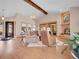 Bright living room with stone fireplace, vaulted ceiling, hardwood floors, view, and natural light from large windows and sliding doors at 1374 Crested Butte Ct, Evergreen, CO 80439