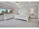 Spacious bedroom with a white furniture set and a large window with a view at 1374 Crested Butte Ct, Evergreen, CO 80439