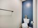 Stylish powder room with blue shiplap accent wall and modern toilet at 1374 Crested Butte Ct, Evergreen, CO 80439