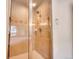 Modern shower with tile surround and glass doors at 1374 Crested Butte Ct, Evergreen, CO 80439