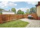 Backyard featuring a well-maintained lawn, privacy fence, and a modern grill for outdoor cooking at 2203 S Lincoln St, Denver, CO 80210