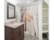Bathroom featuring a stylish vanity, decorative mirror and shower with artistic curtain at 2203 S Lincoln St, Denver, CO 80210