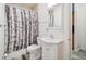 Bathroom with a shower with birch tree pattern curtain and tile floors at 2203 S Lincoln St, Denver, CO 80210