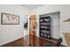 Bedroom with hardwood floors, map artwork, a bookshelf, and a black chair at 2203 S Lincoln St, Denver, CO 80210