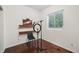 Bedroom with wood floors features a window, desk with shelves, and office equipment at 2203 S Lincoln St, Denver, CO 80210