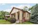Craftsman-style home boasts a brick exterior, covered porch, and well-maintained landscaping at 2203 S Lincoln St, Denver, CO 80210