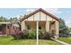 Charming brick home with well-maintained front yard, mature landscaping and inviting front porch at 2203 S Lincoln St, Denver, CO 80210