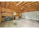 Spacious garage with exposed wood beams, offering ample storage and parking at 2203 S Lincoln St, Denver, CO 80210