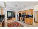 Kitchen showcasing wooden cabinets, stainless steel appliances, decorative rug, and an archway to dining at 2203 S Lincoln St, Denver, CO 80210