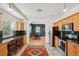 Bright kitchen featuring wooden cabinets, black countertops, stainless steel appliances, and dining area at 2203 S Lincoln St, Denver, CO 80210