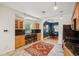 Kitchen with wooden cabinets, breakfast bar seating, stainless steel appliances, and open dining space at 2203 S Lincoln St, Denver, CO 80210