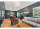 Spacious living room with hardwood floors, cozy seating, and ample natural light for a comfortable atmosphere at 2203 S Lincoln St, Denver, CO 80210
