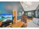 Open-concept living room with hardwood floors, vaulted ceiling, and an inviting archway to the kitchen at 2203 S Lincoln St, Denver, CO 80210