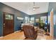 Comfortable living room with a plush recliner, natural light, and hardwood floors offering a relaxing space at 2203 S Lincoln St, Denver, CO 80210