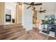 Sunroom featuring brick detailing, multiple ceiling fans, and a standing desk at 2203 S Lincoln St, Denver, CO 80210