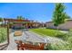 Gravel backyard with a snowboard bench, decorative landscaping, and a view of the home's backyard patio at 2845 Hudson St, Denver, CO 80207