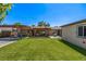 Expansive backyard featuring a covered patio area perfect for outdoor entertaining and relaxation on the lush green lawn at 2845 Hudson St, Denver, CO 80207