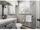 Neutral toned bathroom features modern vanity, updated fixtures and a large mirror at 2845 Hudson St, Denver, CO 80207