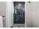 Sleek glass shower with trendy herringbone tile in updated bathroom at 2845 Hudson St, Denver, CO 80207