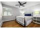 Bedroom boasts hardwood floors, ceiling fan, and a large window for plenty of natural light at 2845 Hudson St, Denver, CO 80207