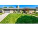Charming home featuring a well-manicured lawn and beautiful landscaping at 2845 Hudson St, Denver, CO 80207