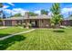 Charming brick home with a well-manicured lawn and inviting walkway at 2845 Hudson St, Denver, CO 80207