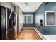 Pantry area in kitchen with stainless steel refrigerator and plenty of storage at 2845 Hudson St, Denver, CO 80207