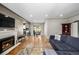 Open-concept living area with a fireplace and seamless flow to dining and kitchen at 2845 Hudson St, Denver, CO 80207