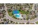 Aerial view showcases community pool and tennis courts surrounded by lush greenery and residences at 6083 S Glencoe Way, Centennial, CO 80121