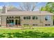 Large backyard featuring green lawn, an open patio and lush landscaping at 6083 S Glencoe Way, Centennial, CO 80121