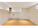 Spacious basement area with overhead storage and a hardwood floor at 6083 S Glencoe Way, Centennial, CO 80121