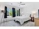 This bedroom features a large window, soft lighting, and a neutral color palette at 6083 S Glencoe Way, Centennial, CO 80121