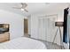This bedroom has a ceiling fan, a television and a large closet with paneled doors at 6083 S Glencoe Way, Centennial, CO 80121