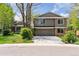 Charming two-story home with a well-maintained lawn, mature trees, and a spacious driveway at 6083 S Glencoe Way, Centennial, CO 80121