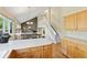 Bright kitchen features light wood cabinets, island, and an open floorplan leading to a cozy living space at 6083 S Glencoe Way, Centennial, CO 80121