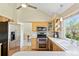Modern kitchen with stainless steel appliances, light wood cabinets, and sleek countertops at 6083 S Glencoe Way, Centennial, CO 80121