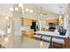 Bright kitchen features light wood cabinets, an island with seating, and modern stainless appliances at 6083 S Glencoe Way, Centennial, CO 80121