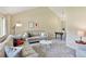 Bright living room featuring neutral tones, vaulted ceilings, and plush seating arrangements at 6083 S Glencoe Way, Centennial, CO 80121