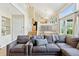 Bright and airy living room with a glimpse of the kitchen area and an open staircase at 6083 S Glencoe Way, Centennial, CO 80121