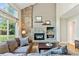 Spacious living room with a stone fireplace, comfortable seating, and plenty of natural light at 6083 S Glencoe Way, Centennial, CO 80121