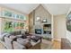 Bright and open living room with a stone fireplace and views of a fenced backyard at 6083 S Glencoe Way, Centennial, CO 80121