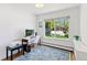 Bright home office featuring a large window with neighborhood views, a desk, and sleek decor at 6083 S Glencoe Way, Centennial, CO 80121
