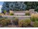 Street view of brick Heritage Village entrance sign with manicured landscaping and mature trees at 6083 S Glencoe Way, Centennial, CO 80121