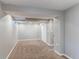 The finished basement features carpet and a utility door to storage at 7163 S Xanthia St, Centennial, CO 80112