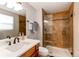 Bathroom featuring glass shower door, wooden vanity, and white countertop at 7163 S Xanthia St, Centennial, CO 80112