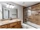 Well-lit bathroom featuring a tiled shower, vanity, and neutral color palette at 7163 S Xanthia St, Centennial, CO 80112