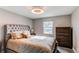 Comfortable bedroom with neutral colors, a large bed, and natural light from the window at 7163 S Xanthia St, Centennial, CO 80112