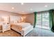 Bedroom with neutral walls, large window for natural light and access to the outdoors at 7163 S Xanthia St, Centennial, CO 80112