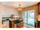 Eat-in kitchen area with an elegant light fixture and sliding glass doors to the patio at 7163 S Xanthia St, Centennial, CO 80112